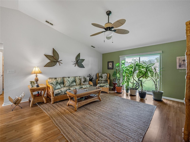 living room with wood-type flooring, vaulted ceiling, and ceiling fan