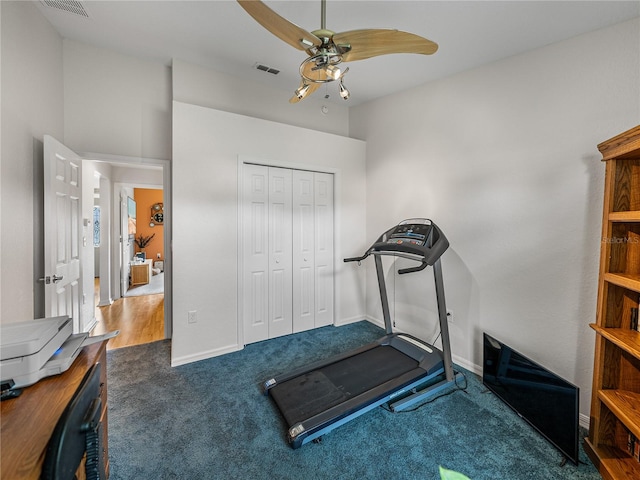 exercise area with ceiling fan and dark hardwood / wood-style flooring