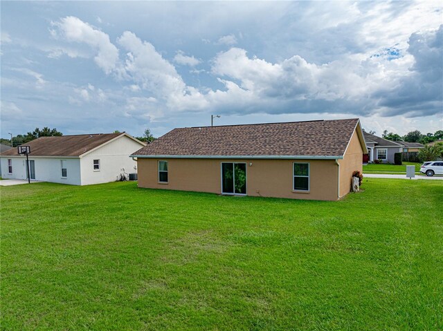 rear view of house featuring a yard