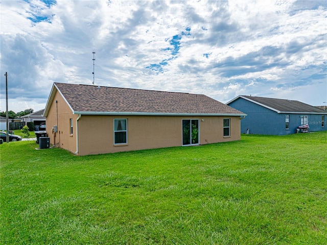 back of house with a lawn