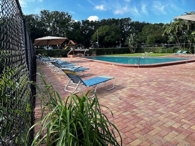 view of swimming pool with a patio area