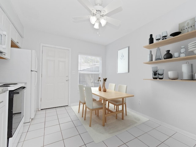 tiled dining space with ceiling fan