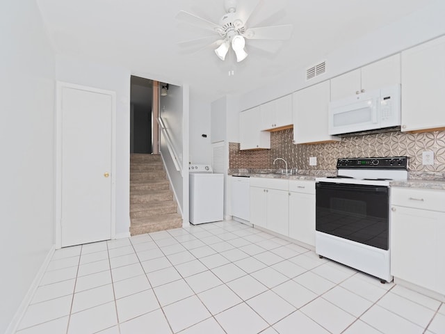 kitchen featuring decorative backsplash, white cabinets, white appliances, and washer / dryer