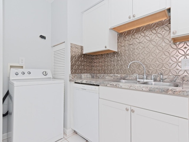 kitchen featuring white dishwasher, washer / clothes dryer, white cabinetry, and backsplash