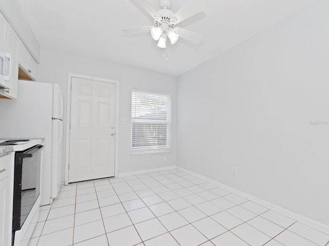 kitchen featuring light tile patterned floors, ceiling fan, electric range, and white cabinets