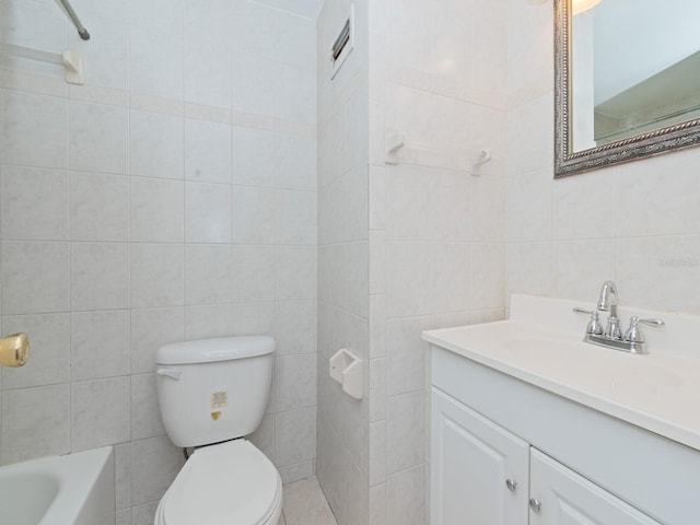 full bathroom featuring tile walls, vanity, toilet, and tiled shower / bath combo