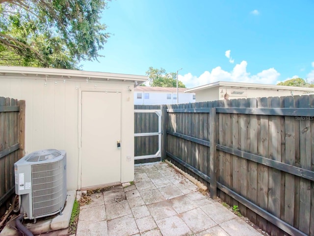 view of patio with a shed and central air condition unit