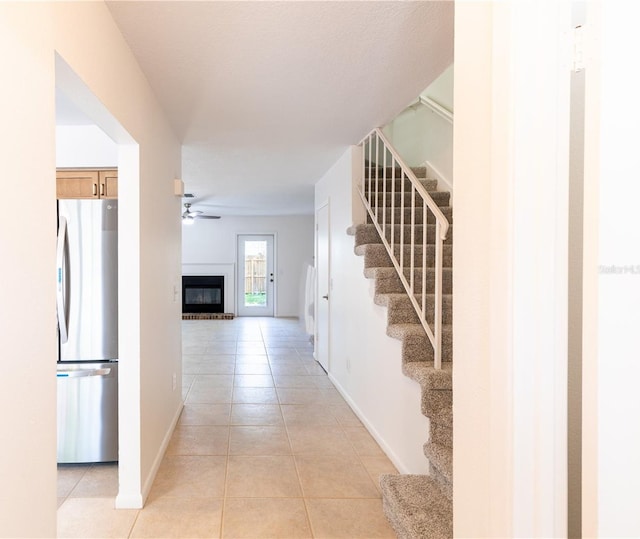 hall featuring light tile patterned floors