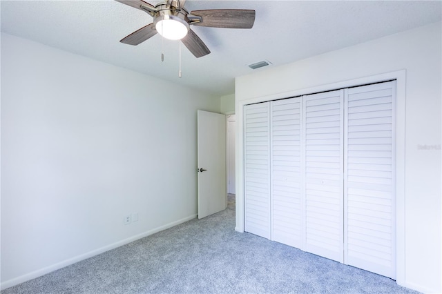 unfurnished bedroom with a closet, ceiling fan, and carpet flooring