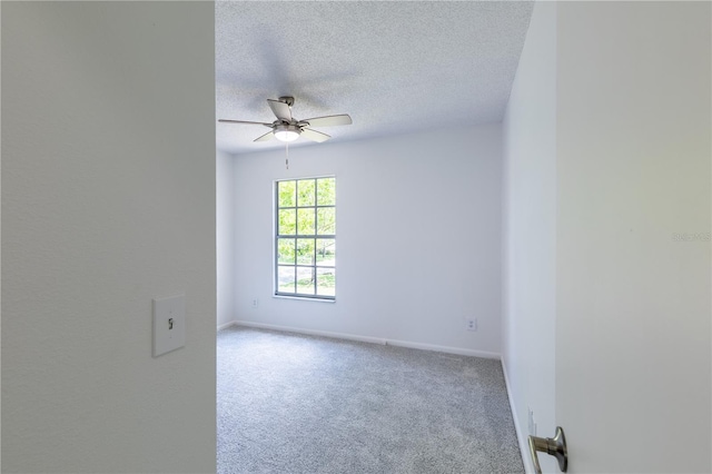 empty room with light carpet, ceiling fan, and a textured ceiling