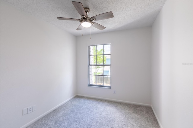 spare room with ceiling fan, carpet floors, and a textured ceiling