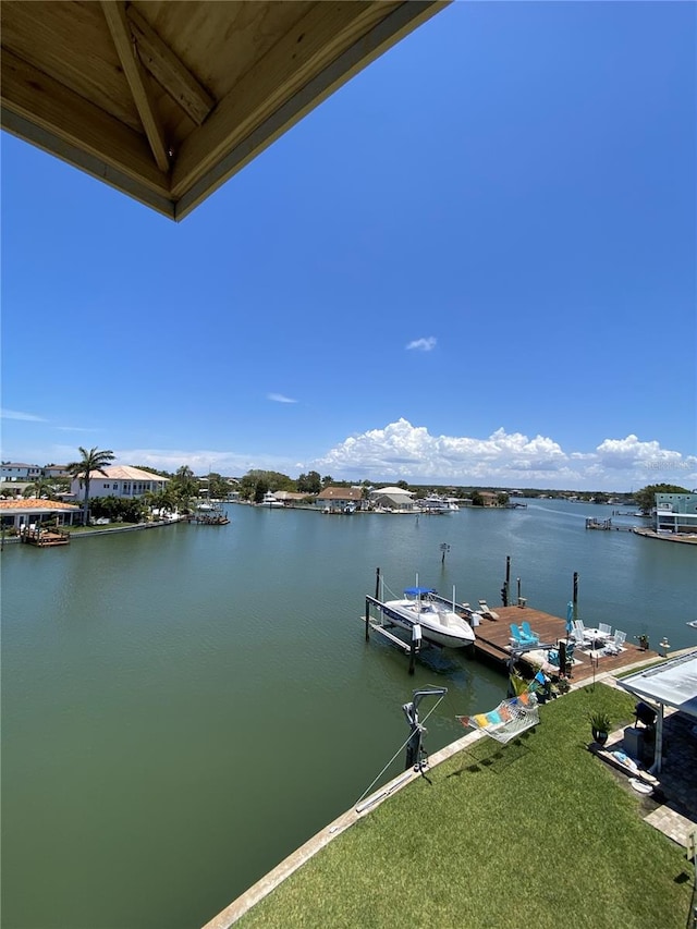 dock area featuring a water view and a yard