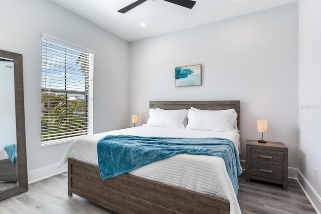 bedroom with ceiling fan and hardwood / wood-style flooring