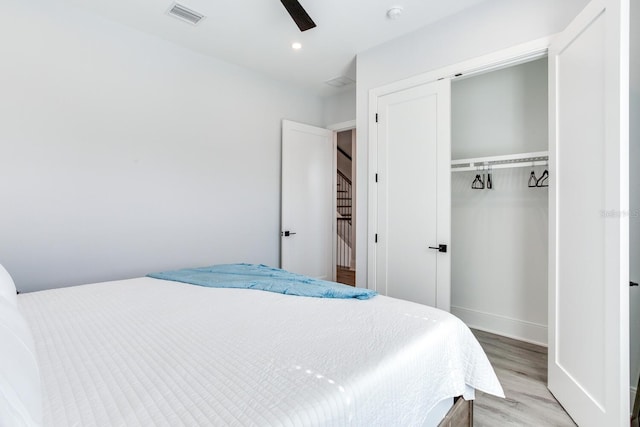 bedroom featuring ceiling fan, a closet, and hardwood / wood-style floors