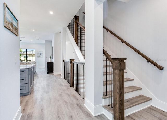 stairs with hardwood / wood-style flooring