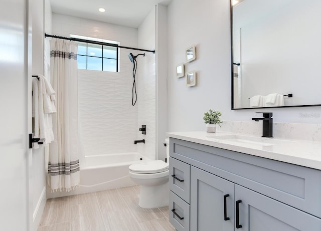 full bathroom featuring shower / bath combo, vanity, and toilet