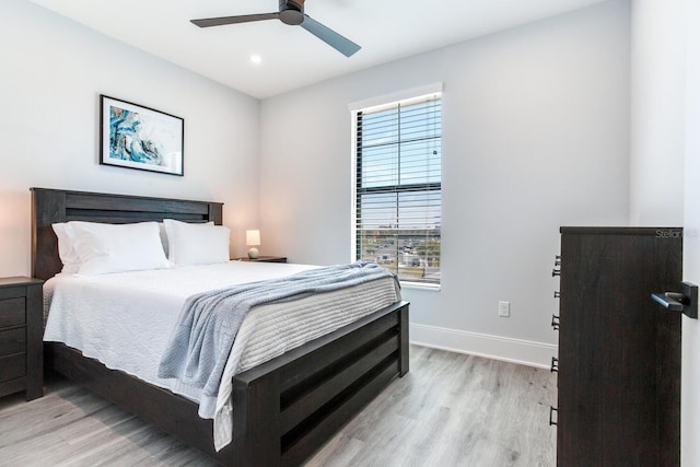 bedroom featuring ceiling fan and light hardwood / wood-style flooring