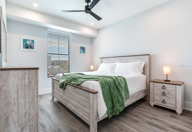 bedroom with ceiling fan and dark hardwood / wood-style flooring