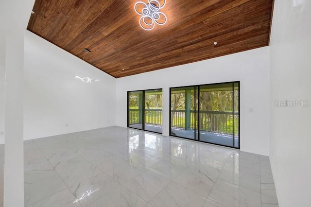 unfurnished room featuring vaulted ceiling and wooden ceiling