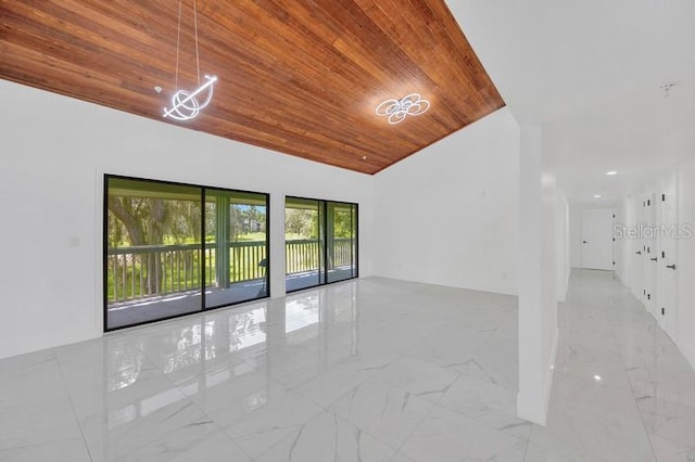 empty room with vaulted ceiling and wooden ceiling