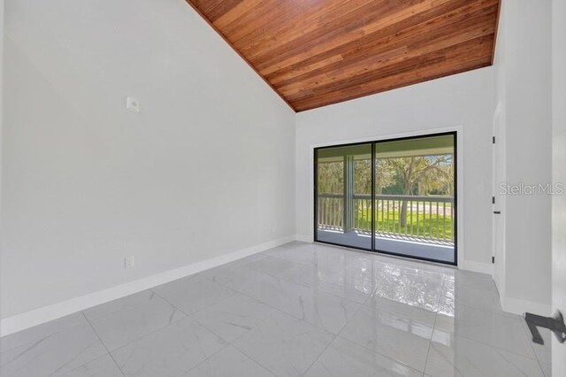 spare room with high vaulted ceiling and wooden ceiling