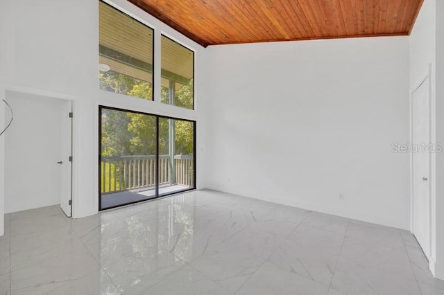 unfurnished room featuring wood ceiling and high vaulted ceiling