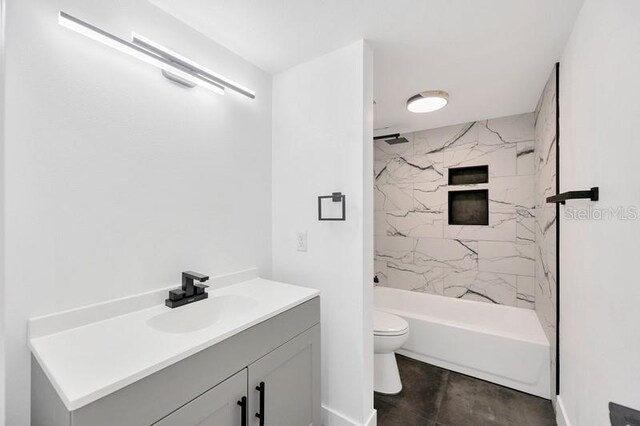 full bathroom featuring vanity, tiled shower / bath combo, and toilet