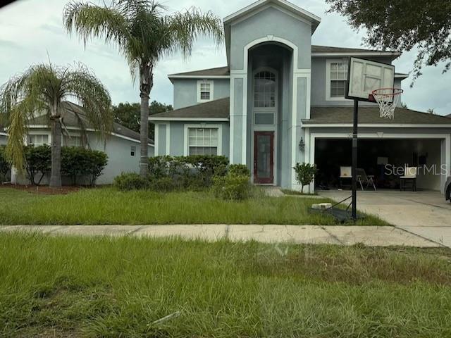 view of front of house with a garage and a front yard