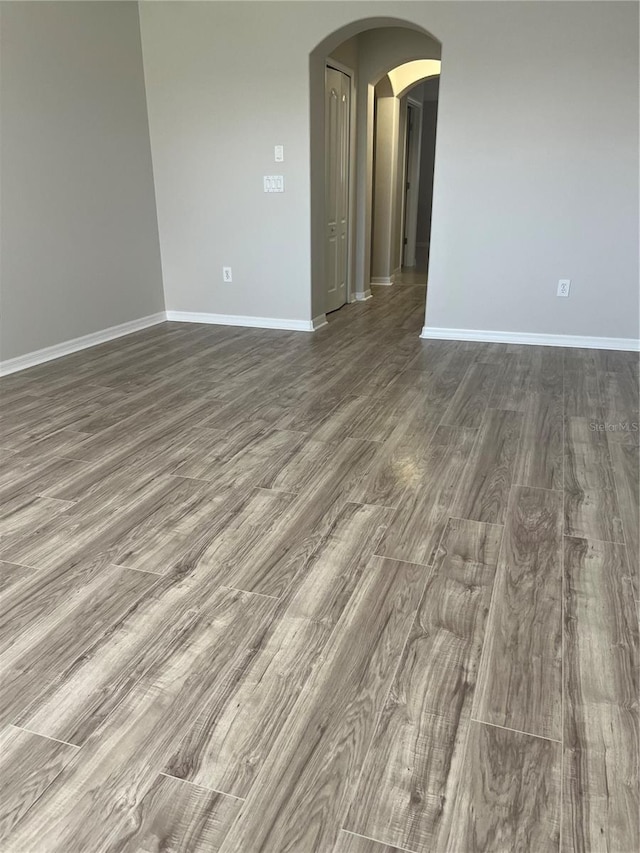 unfurnished room featuring dark hardwood / wood-style floors