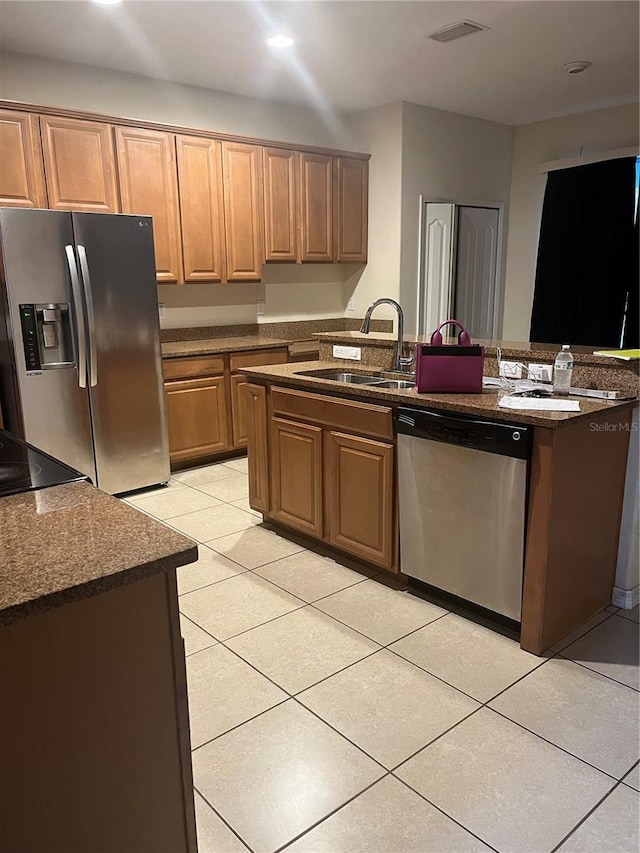 kitchen featuring sink, light tile patterned floors, and appliances with stainless steel finishes