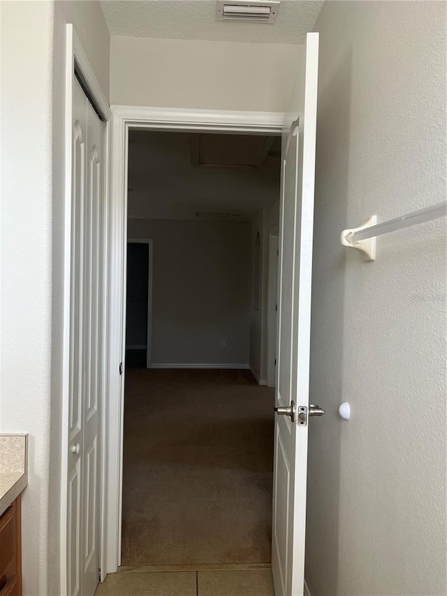 hallway with carpet flooring