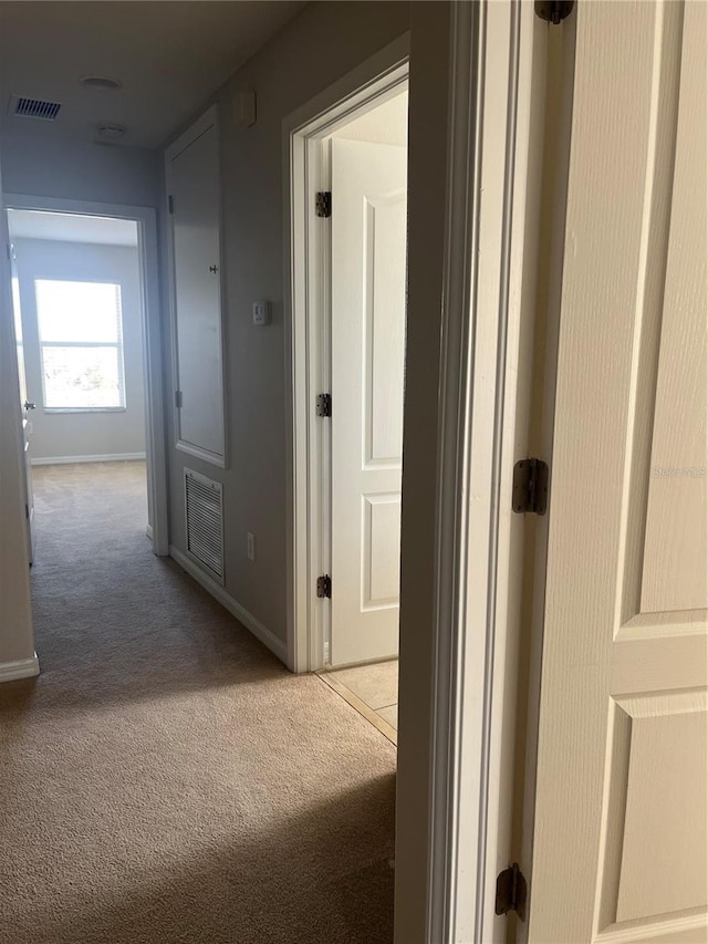 hallway featuring light carpet