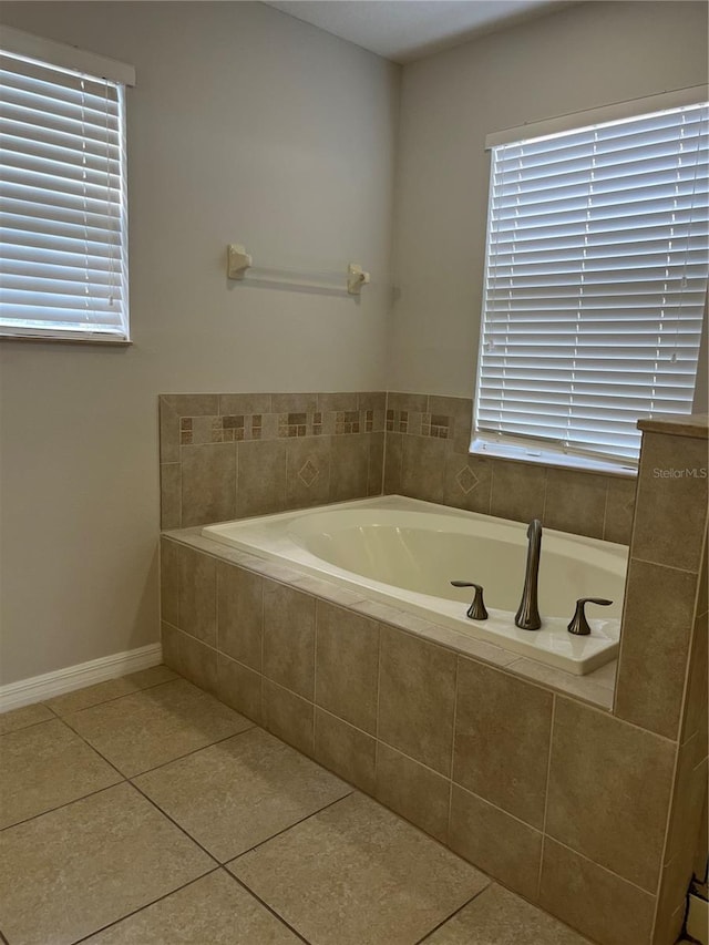 bathroom featuring tile patterned floors and tiled tub