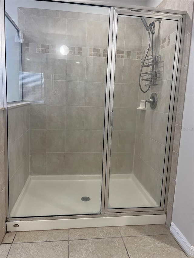 bathroom featuring an enclosed shower and tile patterned flooring