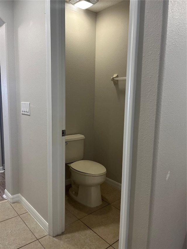 bathroom featuring tile patterned floors and toilet