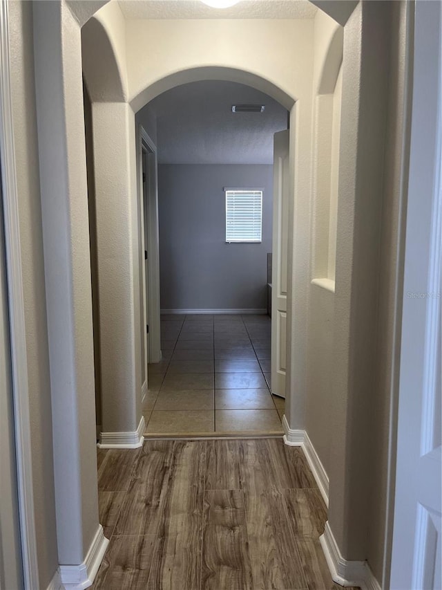 corridor featuring dark wood-type flooring