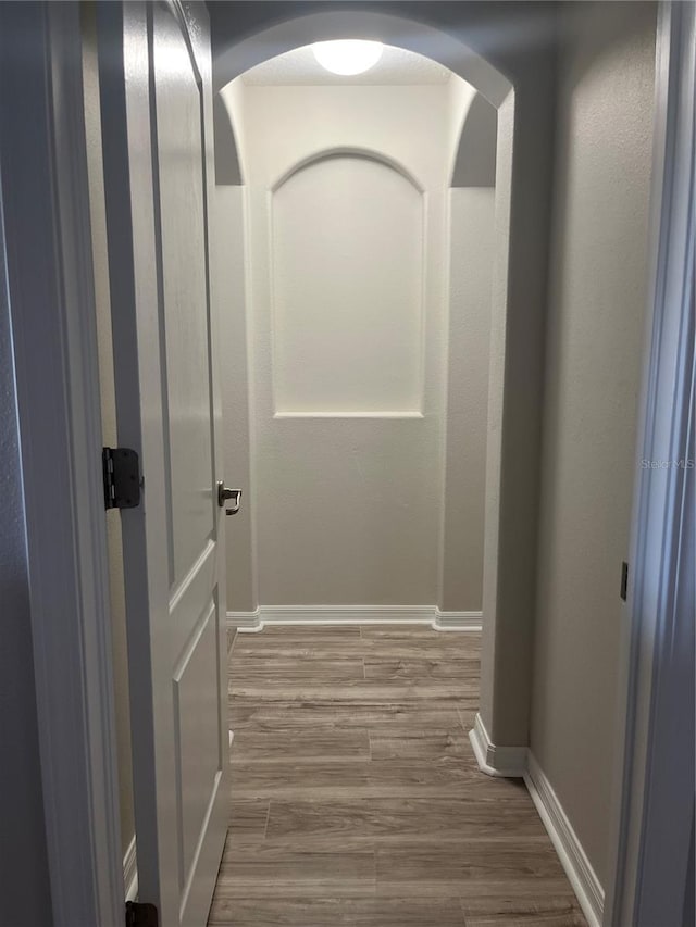 hallway with hardwood / wood-style floors