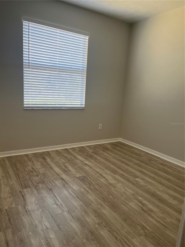 unfurnished room featuring hardwood / wood-style floors