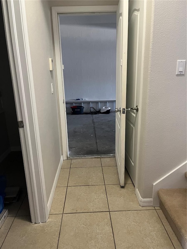 corridor featuring light tile patterned floors