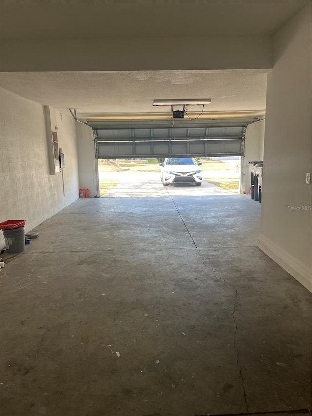 garage featuring a garage door opener and electric panel