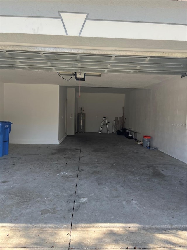 garage with a garage door opener and electric water heater