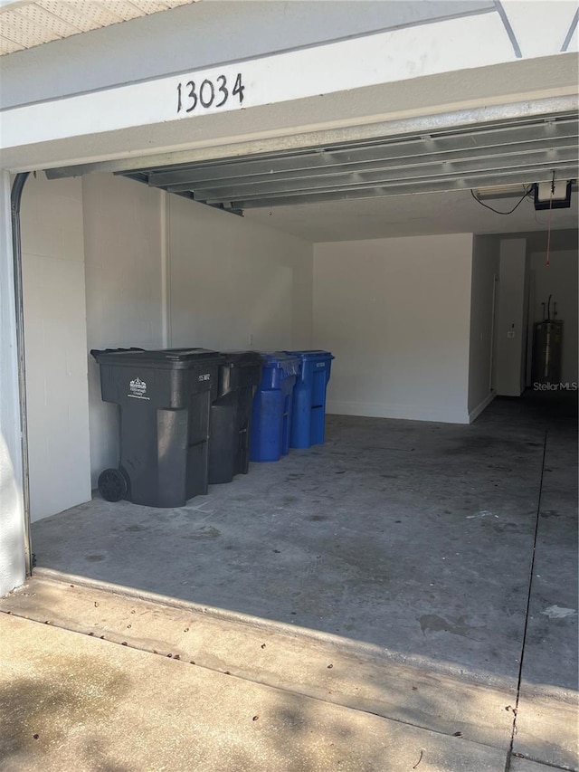 garage with a garage door opener and water heater