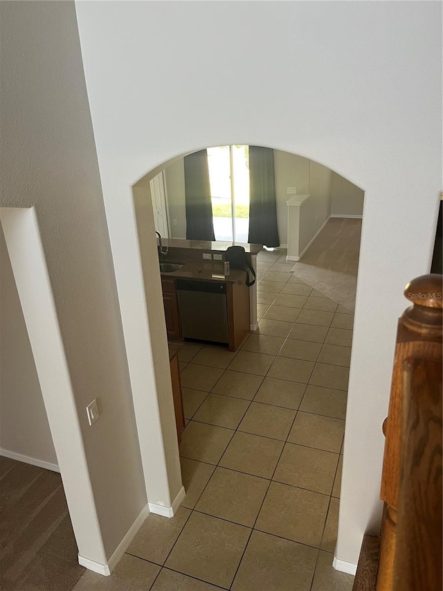 hall with sink and light tile patterned floors