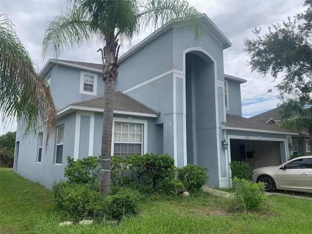 view of property exterior with a garage and a lawn