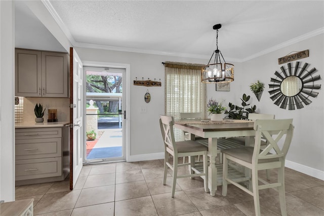 dining space featuring light tile patterned floors, a textured ceiling, a wealth of natural light, and ornamental molding