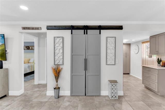 kitchen with light tile patterned floors, gray cabinets, and crown molding