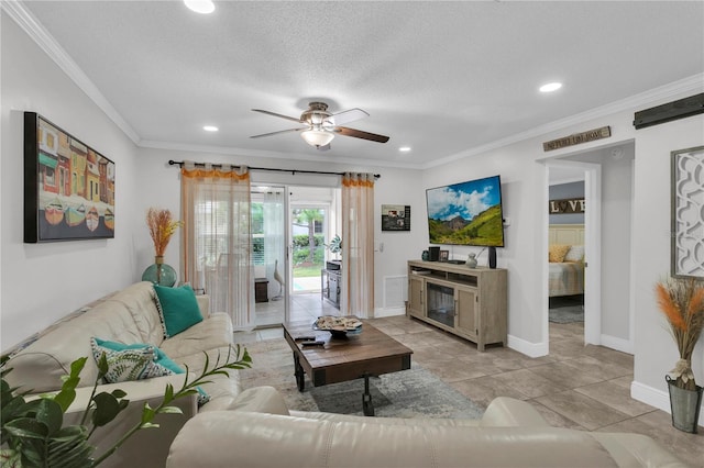 living room featuring light tile patterned floors, a textured ceiling, ceiling fan, and ornamental molding