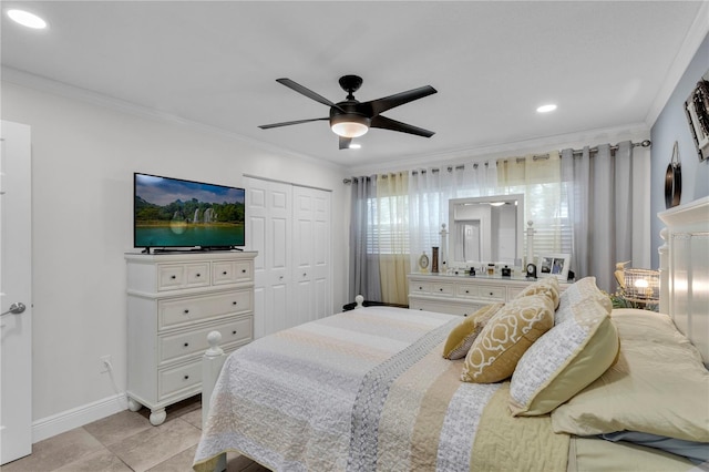 tiled bedroom with ceiling fan, crown molding, and a closet