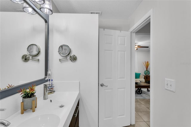 bathroom featuring tile patterned flooring, vanity, a textured ceiling, and ceiling fan