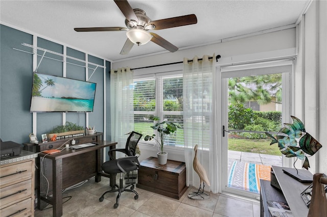 office space featuring ceiling fan, a healthy amount of sunlight, and a textured ceiling